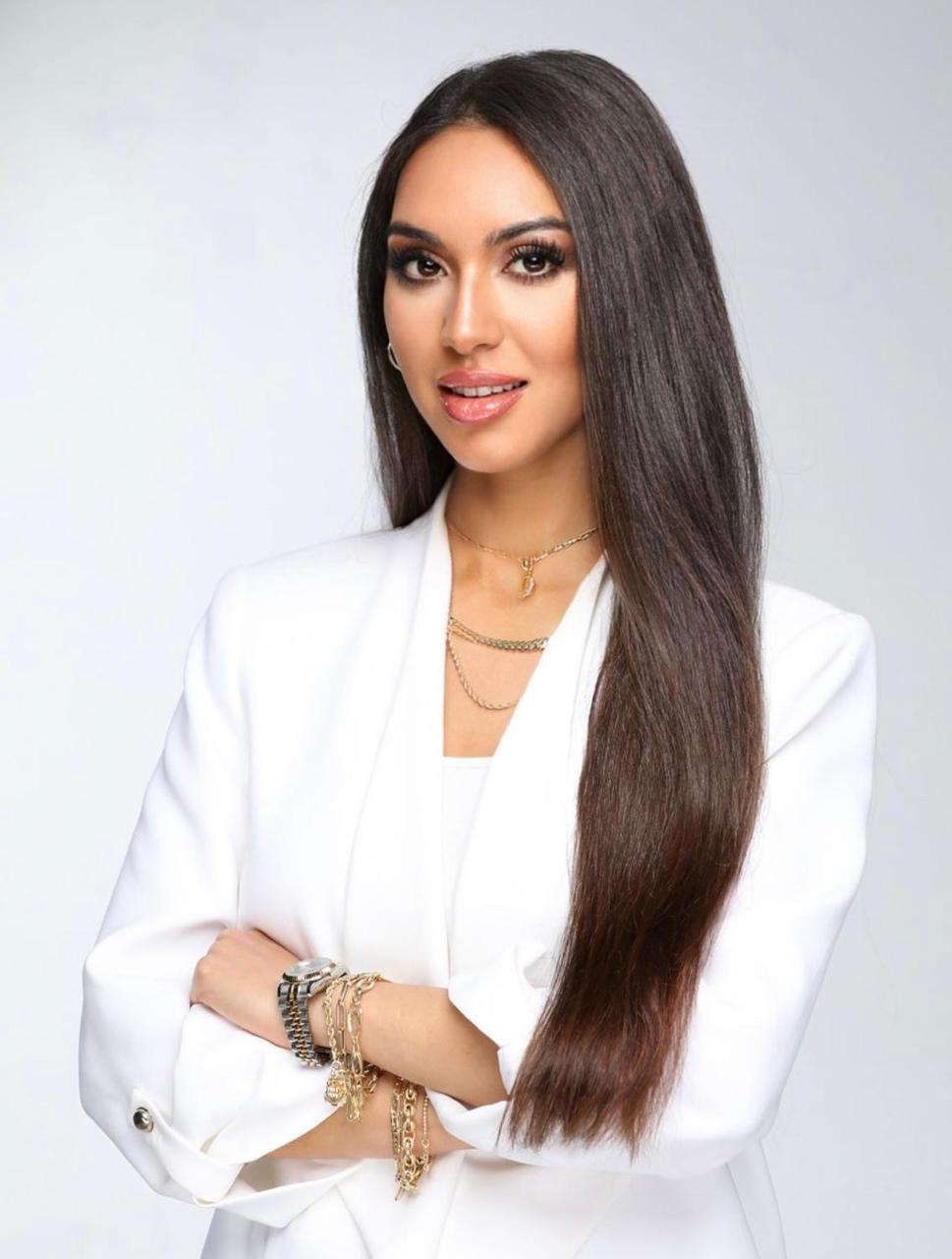 Amanda Gagliano in a white suit with her arms crossed